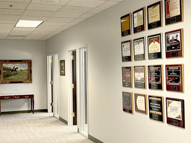 Photo of office interior with wall displaying awards